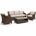 Conjunto de muebles de ratán con cojines beige y mesa de vidrio templado